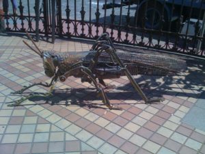 Metal sculpture of a grasshopper