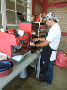 A cupper grinds coffee beans