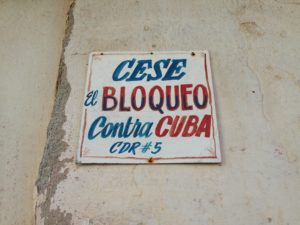 This sign reads, "End the embargo against Cuba." In Cuba you frequently see signs and billboards with political slogans like this. They typically either champion socialism and solidarity - or call on the U.S. to end the embargo or release the Cuban Five.