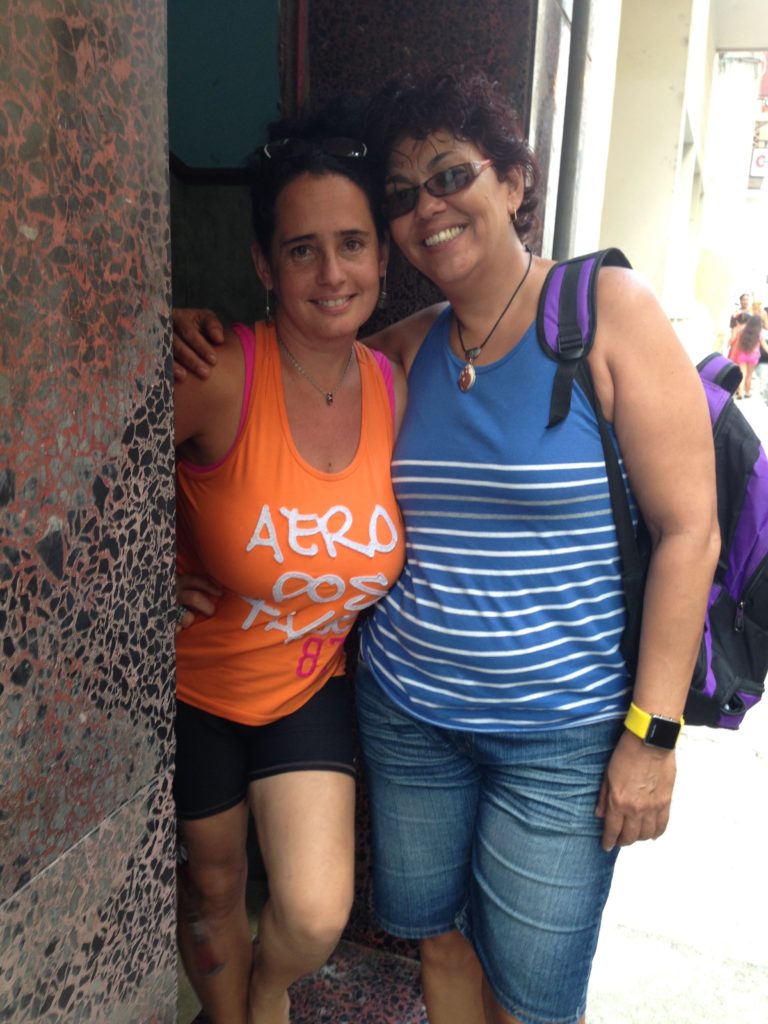 Two women pose for the camera and smile