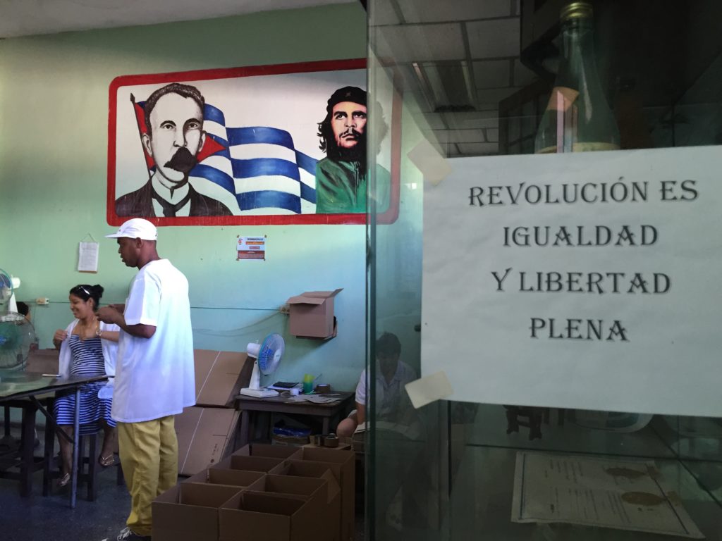 A shot of a patriotic slogan and mural in the Guayabita factory