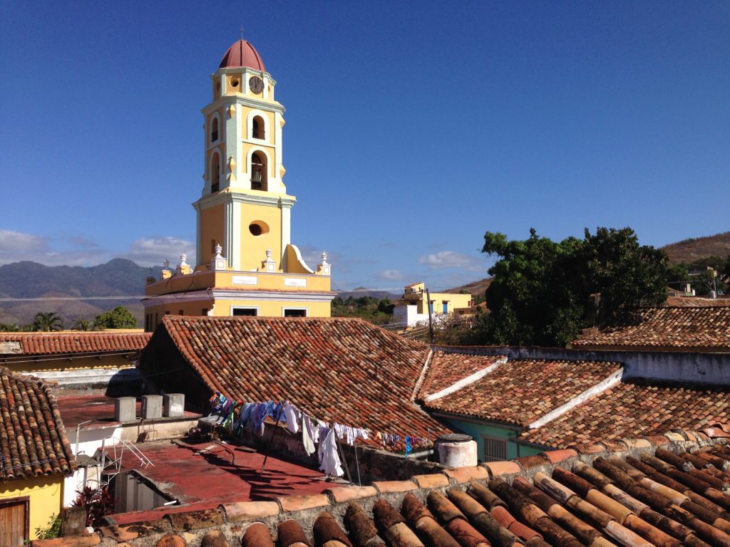 A shot over the rooftops of Trinidad, Cuba to the bell tower of the San Francisco de Asis church