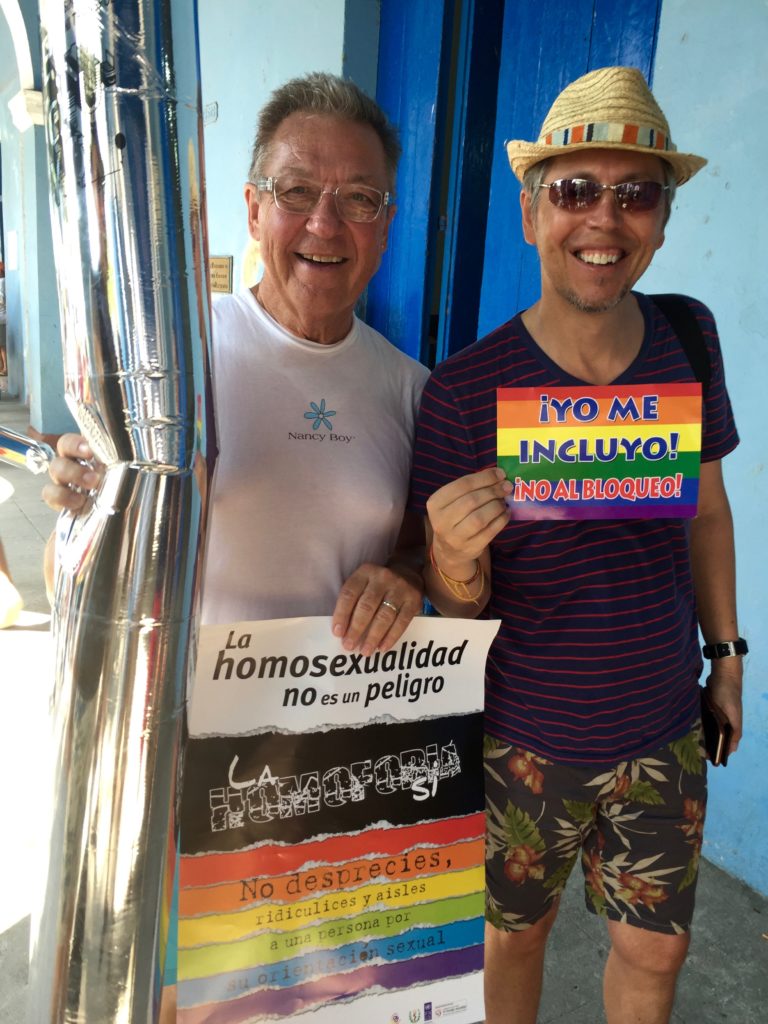 Stephen and Ian show off some swag at the Pride parade staging area! Ian's little rainbow sign says, "I'm in! No to the embargo." Stephen's poster reads, "Homosexuality isn't dangerous. Homophobia is."