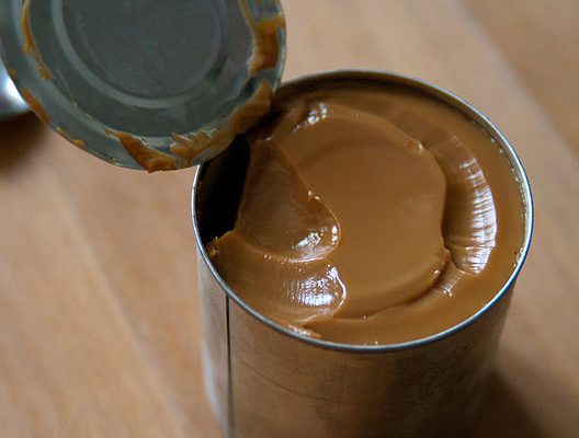 a can of freshly made dulce de leche