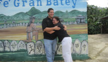 Hugging in front of a mural