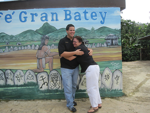 Hugging in front of a mural