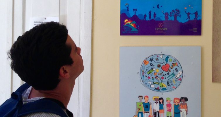 A man looks at colorful posters on the wall