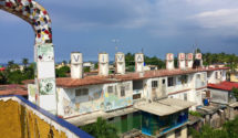 A row of water tanks each is painted with one letter, spelling out Viva Cuba